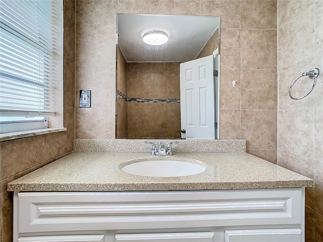 bathroom with tile walls and vanity