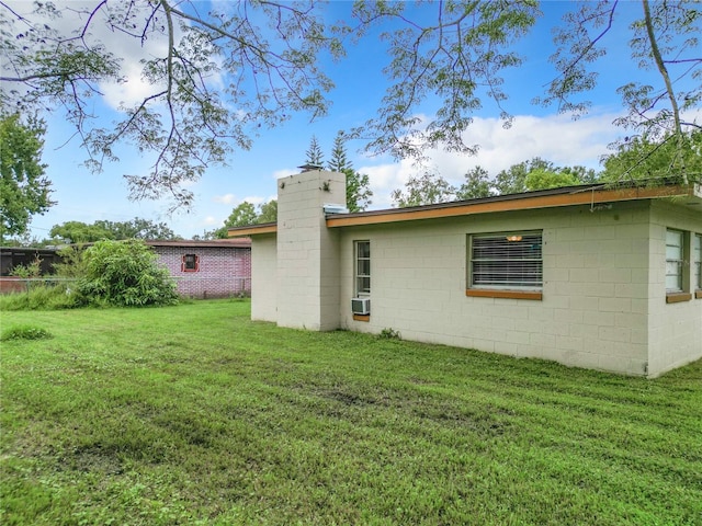 back of house featuring a yard and cooling unit