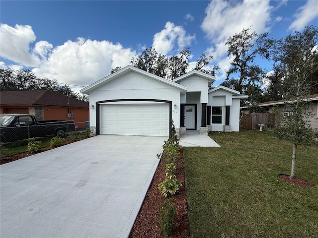 view of front of home with a garage and a front lawn