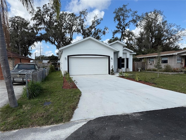 view of front of property featuring a garage and a front yard