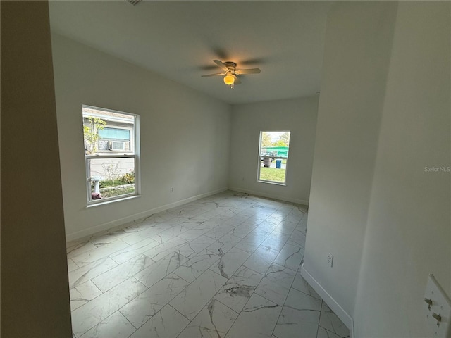 empty room featuring ceiling fan and a healthy amount of sunlight