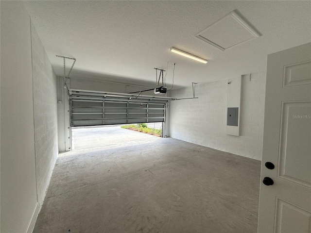 garage with a garage door opener and electric panel