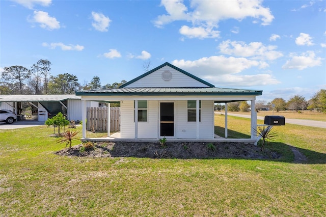 rear view of property featuring a yard