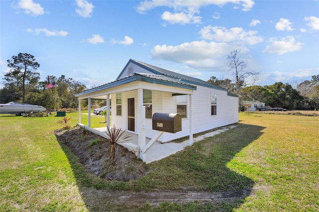 view of side of home featuring a lawn