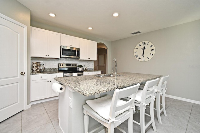 kitchen with white cabinetry, sink, a center island with sink, and appliances with stainless steel finishes