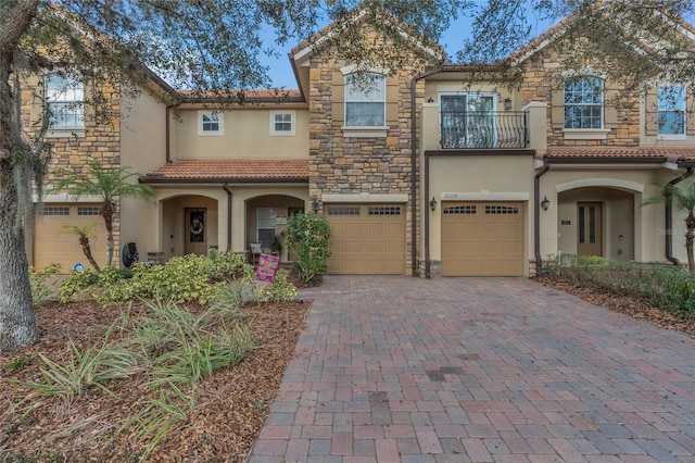 view of front of property featuring a garage and a balcony