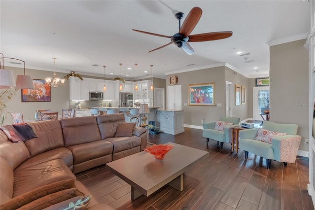 living room featuring dark wood-type flooring, crown molding, and ceiling fan with notable chandelier