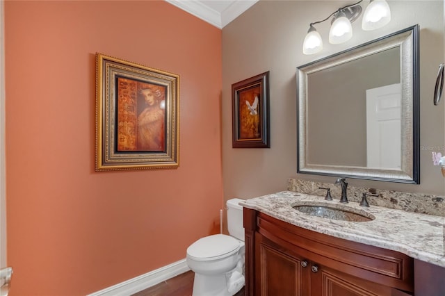 bathroom featuring vanity, crown molding, wood-type flooring, and toilet