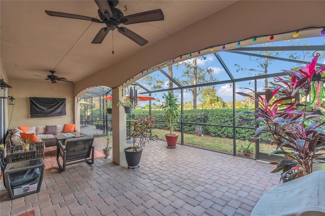 view of patio / terrace with a lanai, an outdoor hangout area, and ceiling fan