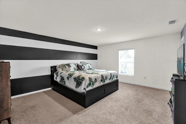 carpeted bedroom featuring visible vents and baseboards