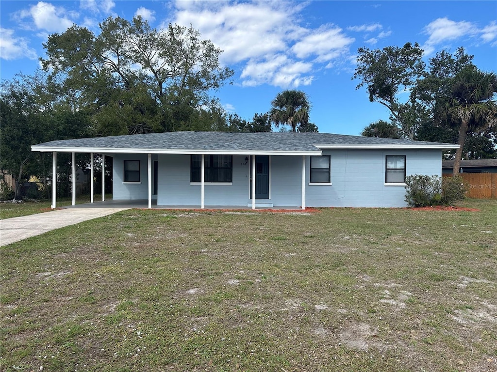 ranch-style house with a carport, a front yard, and covered porch