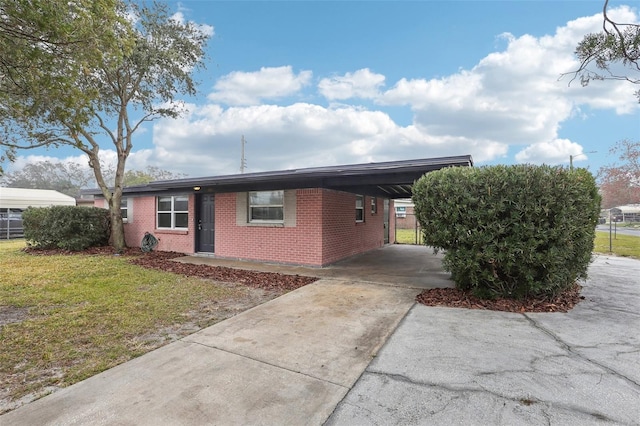 view of front of property featuring a front lawn and a carport