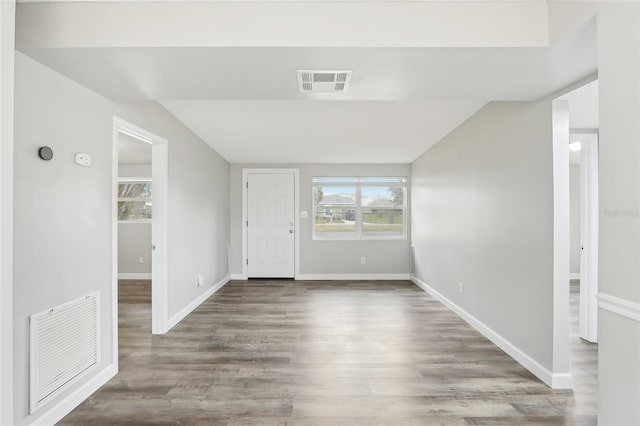 entryway featuring lofted ceiling and hardwood / wood-style floors