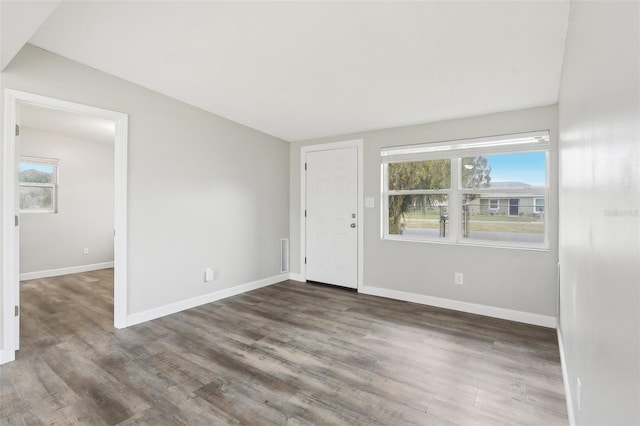 spare room featuring dark wood-type flooring