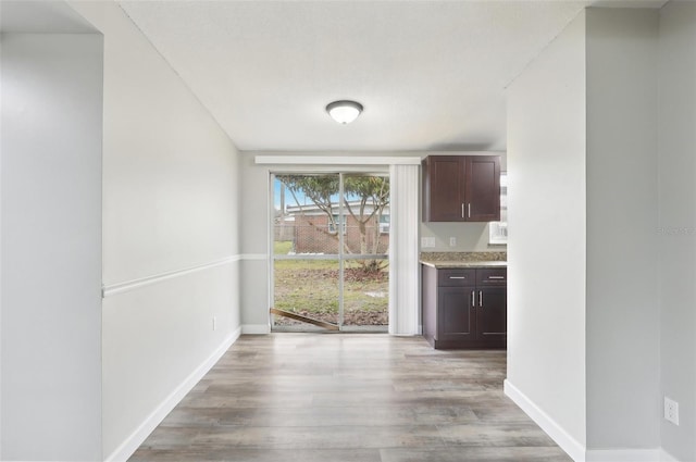 unfurnished dining area featuring light hardwood / wood-style flooring