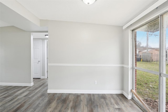 unfurnished room with wood-type flooring