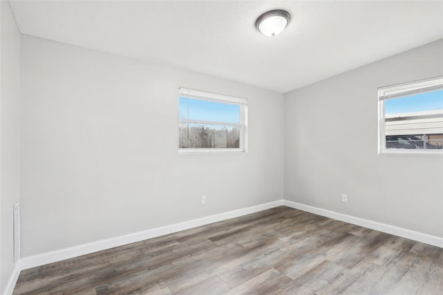 empty room with hardwood / wood-style flooring