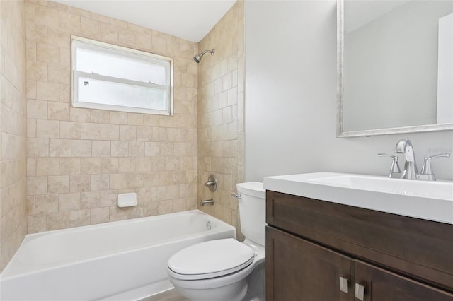 full bathroom featuring toilet, vanity, and tiled shower / bath