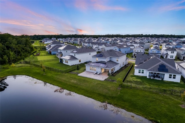 aerial view at dusk with a water view