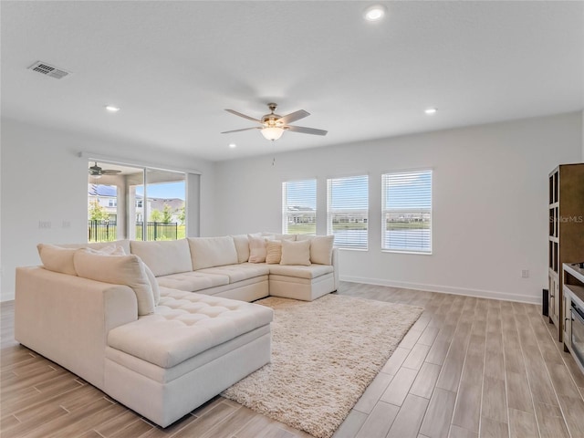 living room with a wealth of natural light and ceiling fan