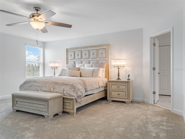 bedroom with ceiling fan and light carpet