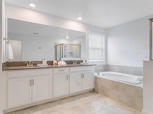 bathroom featuring vanity, shower with separate bathtub, and tile patterned flooring