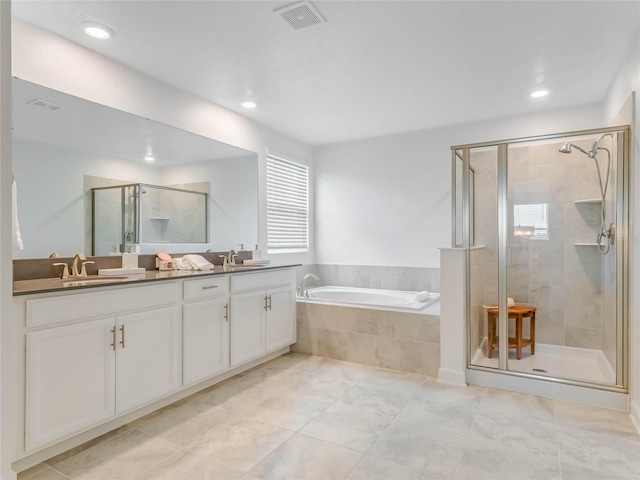 bathroom with vanity, tile patterned flooring, and independent shower and bath