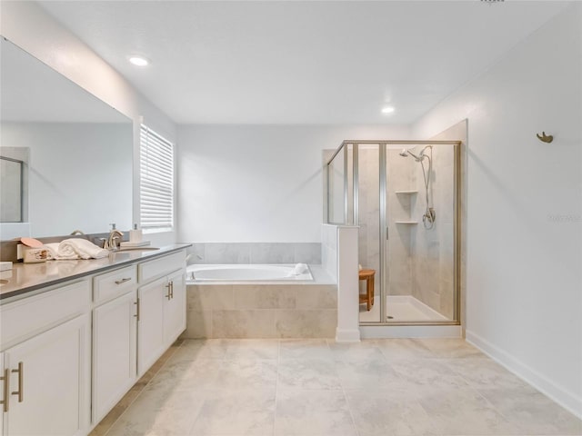 bathroom with vanity and independent shower and bath