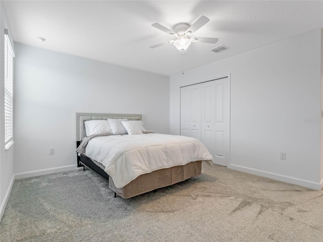 carpeted bedroom with a closet and ceiling fan