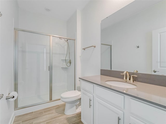 bathroom with vanity, toilet, and an enclosed shower