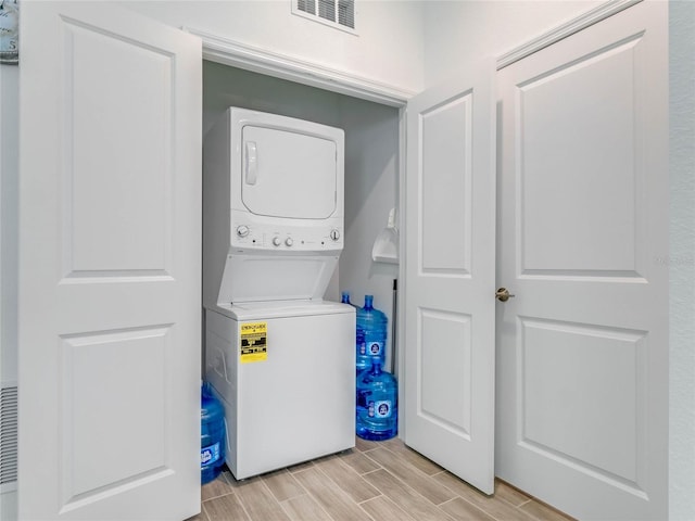 laundry area with stacked washer and dryer