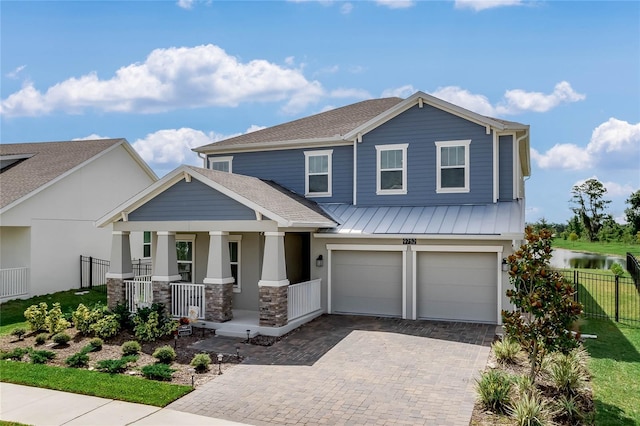 craftsman house with a porch and a garage