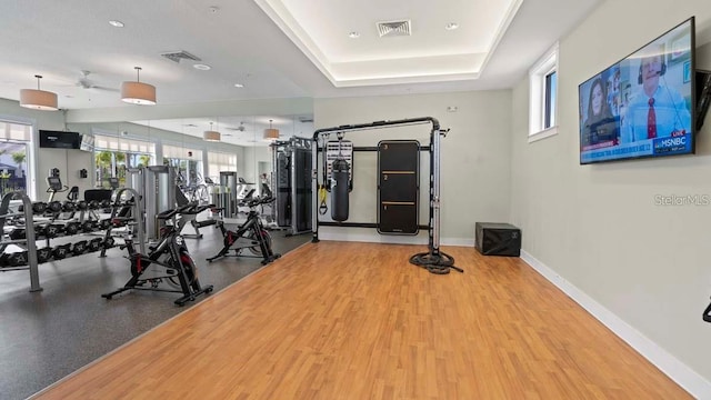 gym with a raised ceiling