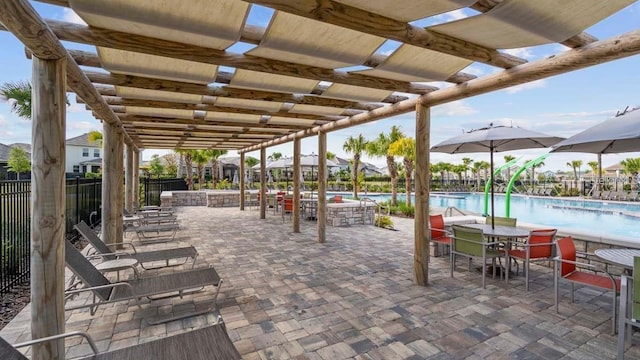 view of community with a pergola, a swimming pool, and a patio area