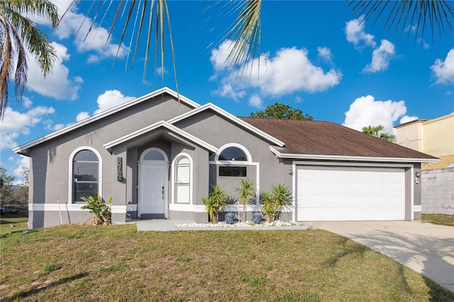 view of front facade with a garage and a front lawn