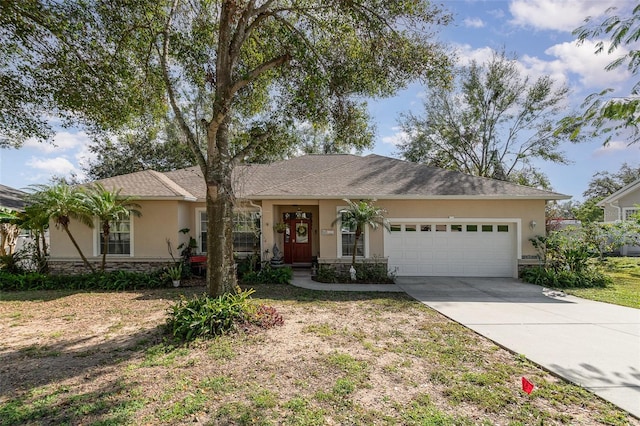 ranch-style house featuring a garage and a front lawn