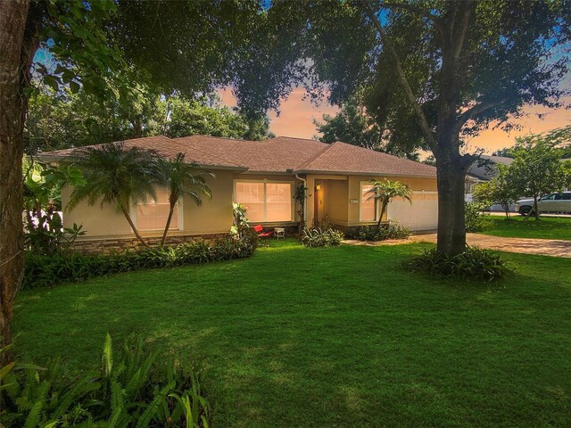 1224 Shorecrest Cir, Clermont, FL 34711 - ranch-style home featuring stucco siding, a front lawn, driveway, an attached garage, and stone siding