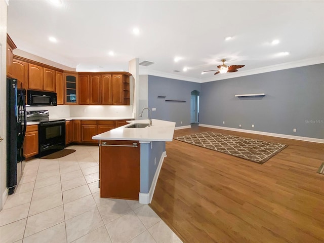 1224 Shorecrest Cir, Clermont, FL 34711 - kitchen with black appliances, a sink, crown molding, arched walkways, and a ceiling fan