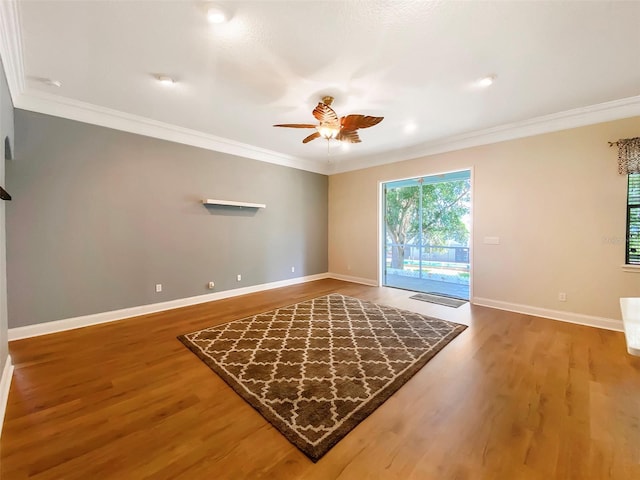 1224 Shorecrest Cir, Clermont, FL 34711 - empty room featuring wood finished floors, crown molding, a ceiling fan, and baseboards