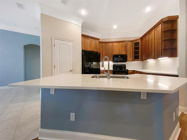 1224 Shorecrest Cir, Clermont, FL 34711 - kitchen featuring black appliances, a sink, a center island with sink, light countertops, and open shelves