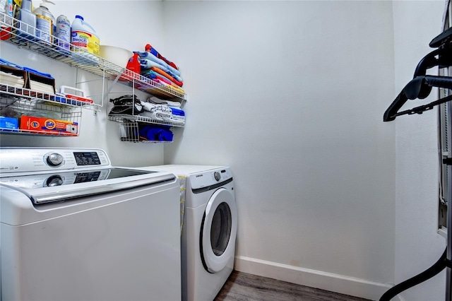 washroom featuring washing machine and dryer and dark hardwood / wood-style floors