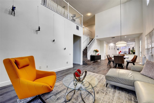 living room with hardwood / wood-style floors and a high ceiling