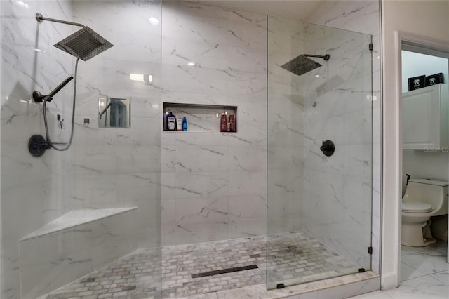 bathroom with tiled shower and toilet