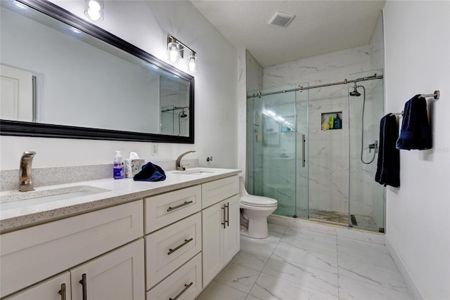 bathroom with vanity, a textured ceiling, toilet, and walk in shower