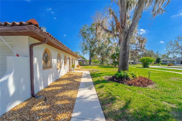 view of property exterior featuring a lawn