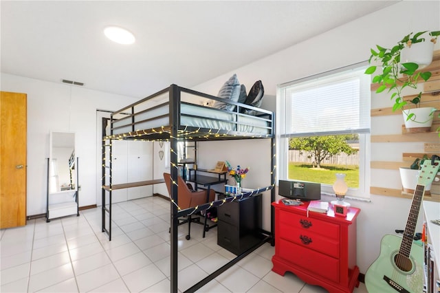 bedroom with light tile patterned floors