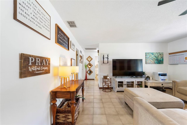 tiled living room with a textured ceiling