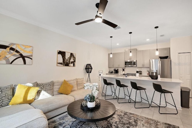 living room featuring crown molding, ceiling fan, and light tile patterned floors