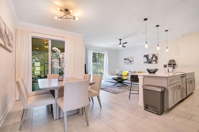 dining space with ornamental molding and ceiling fan