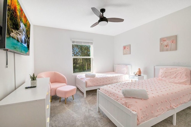 bedroom featuring light colored carpet and ceiling fan